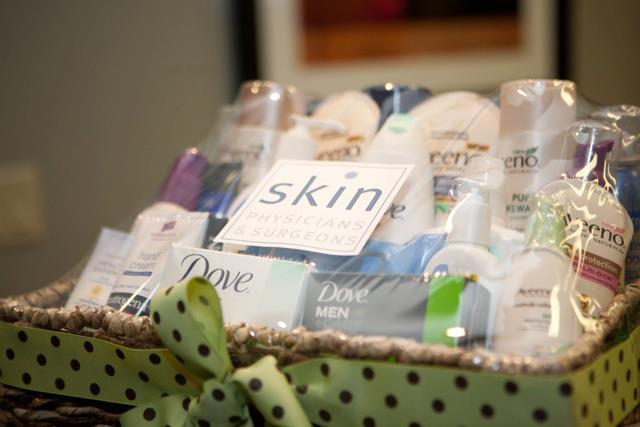 Gift basket with green polka dot ribbon filled with skincare products 