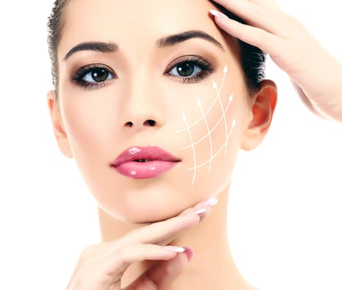 A beautiful woman's face with white lines creating a grid on her cheek, on a white background