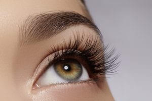 Beautiful macro shot of female eye with extreme long eyelashes and black liner makeup